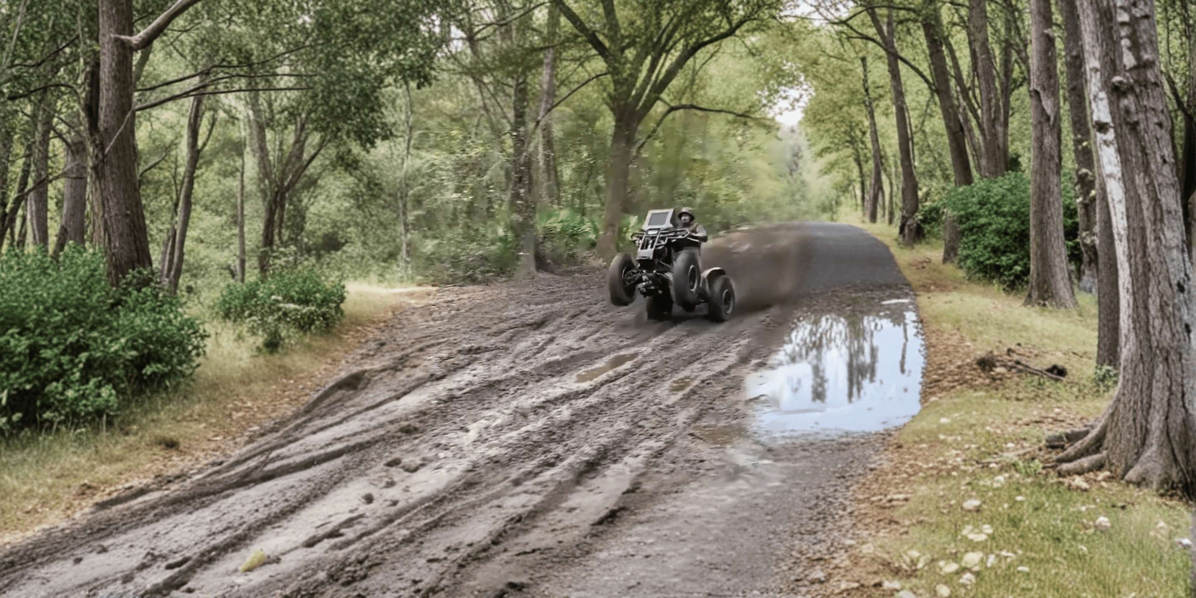 Professional ATV tearing through mud with dramatic lighting - Blaizn Trails Performance tuning services